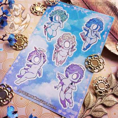 Sticker sheet of cherubs holding knives. Weirdcore aesthetic.